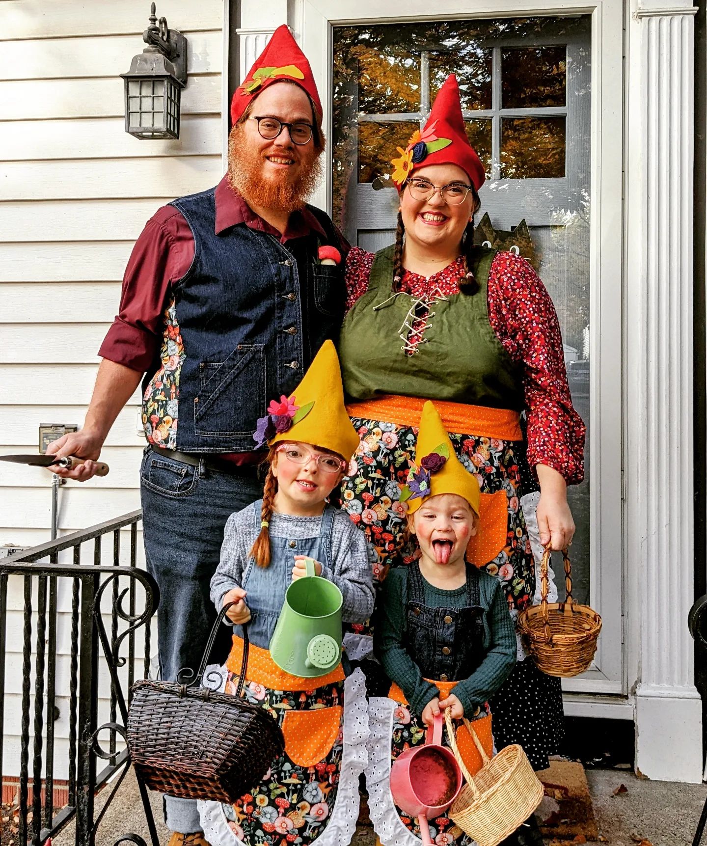 A mother, father, and two little girls dressed up as gnomes for Halloween.